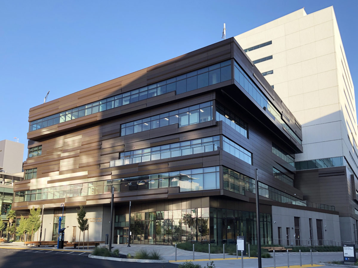 Modern multi-story building with glass windows.