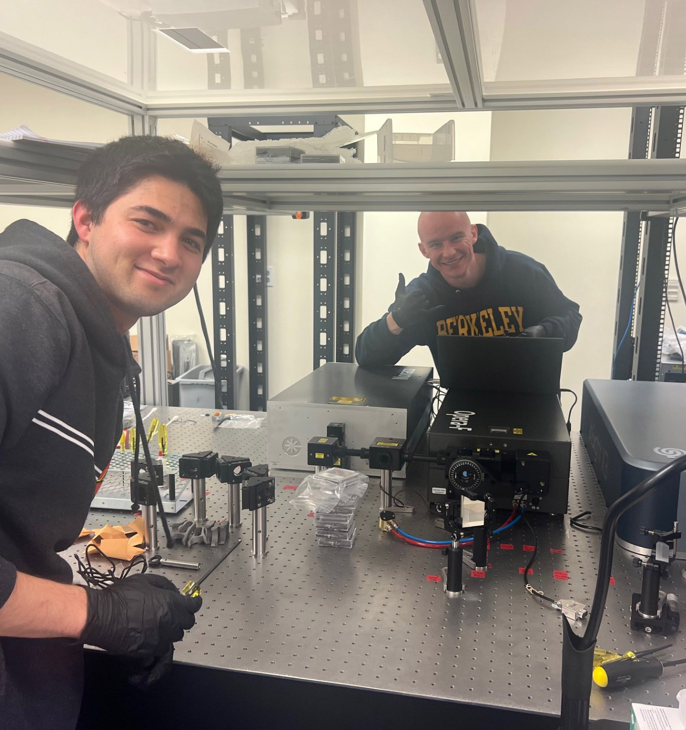 Two researchers working in a lab with scientific equipment.