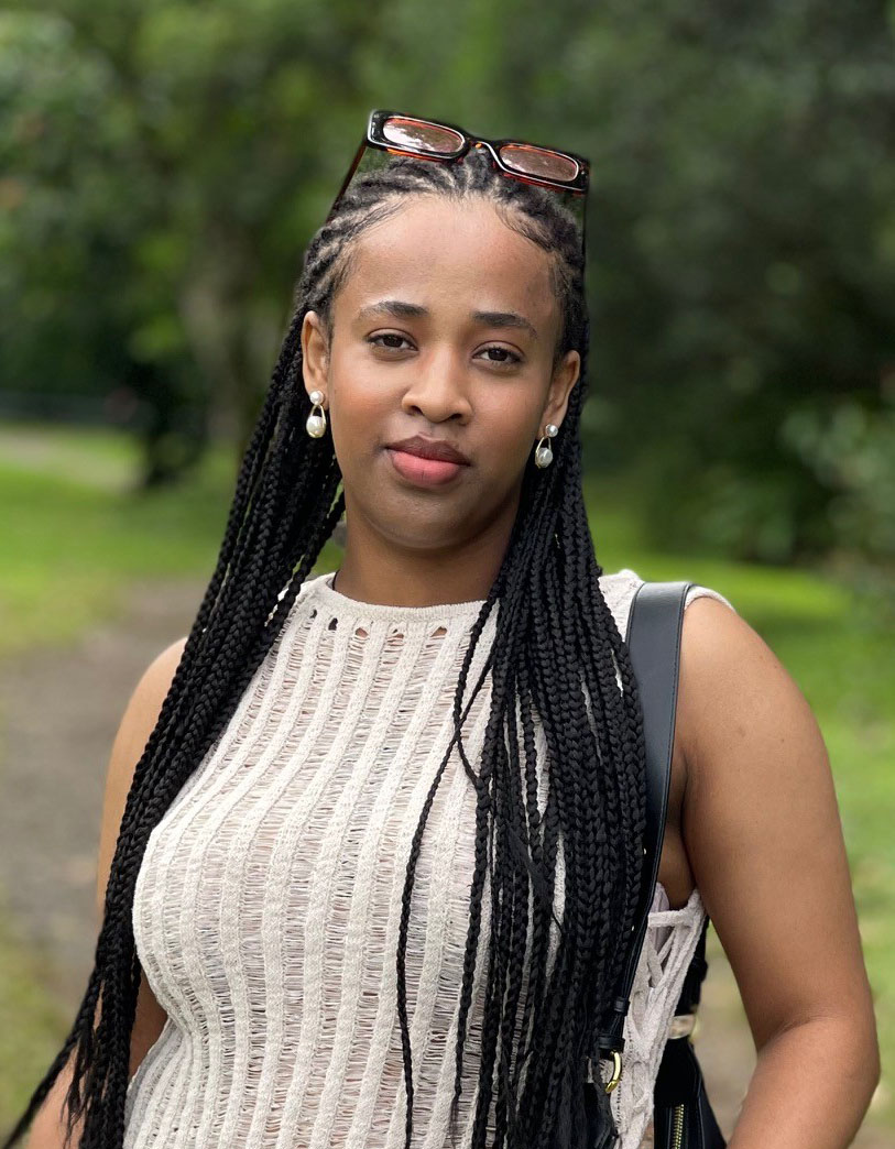 A woman with long braids standing outdoors. Ou Lab Research People UCSF Yvonne.