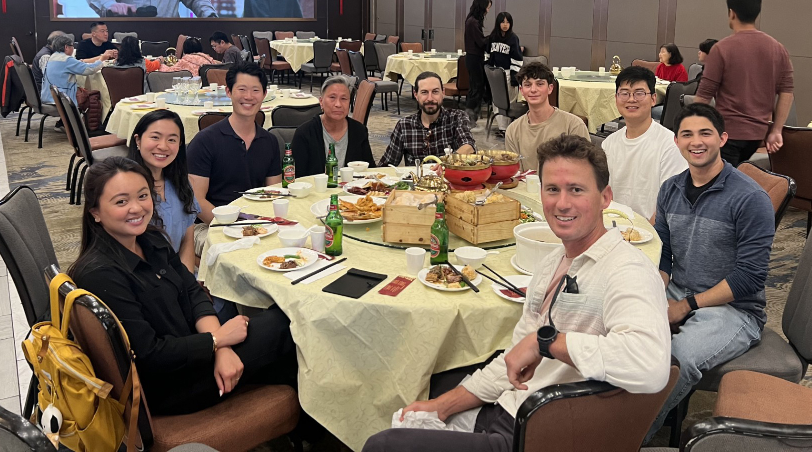 Group of eight people at a dining table.