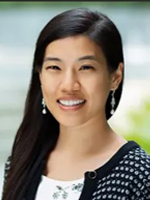 Woman with long black hair and earrings.