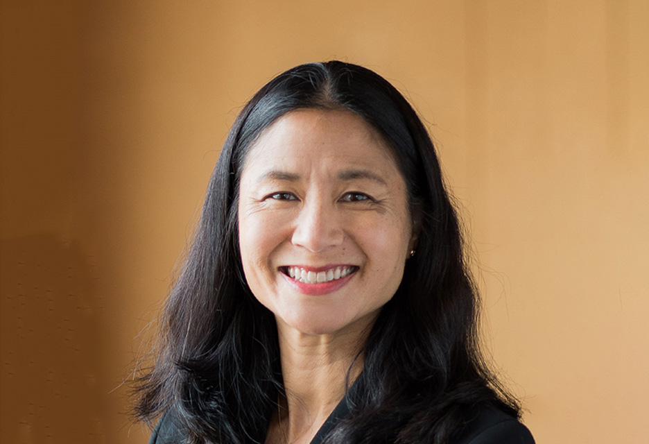 Smiling woman with long black hair.
