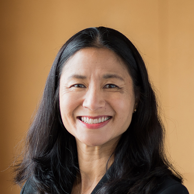 Smiling woman with long dark hair.