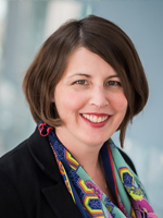 Woman with brown hair and colorful scarf.