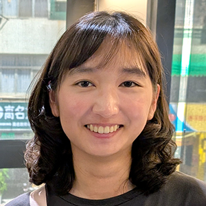 Smiling woman with curly hair.