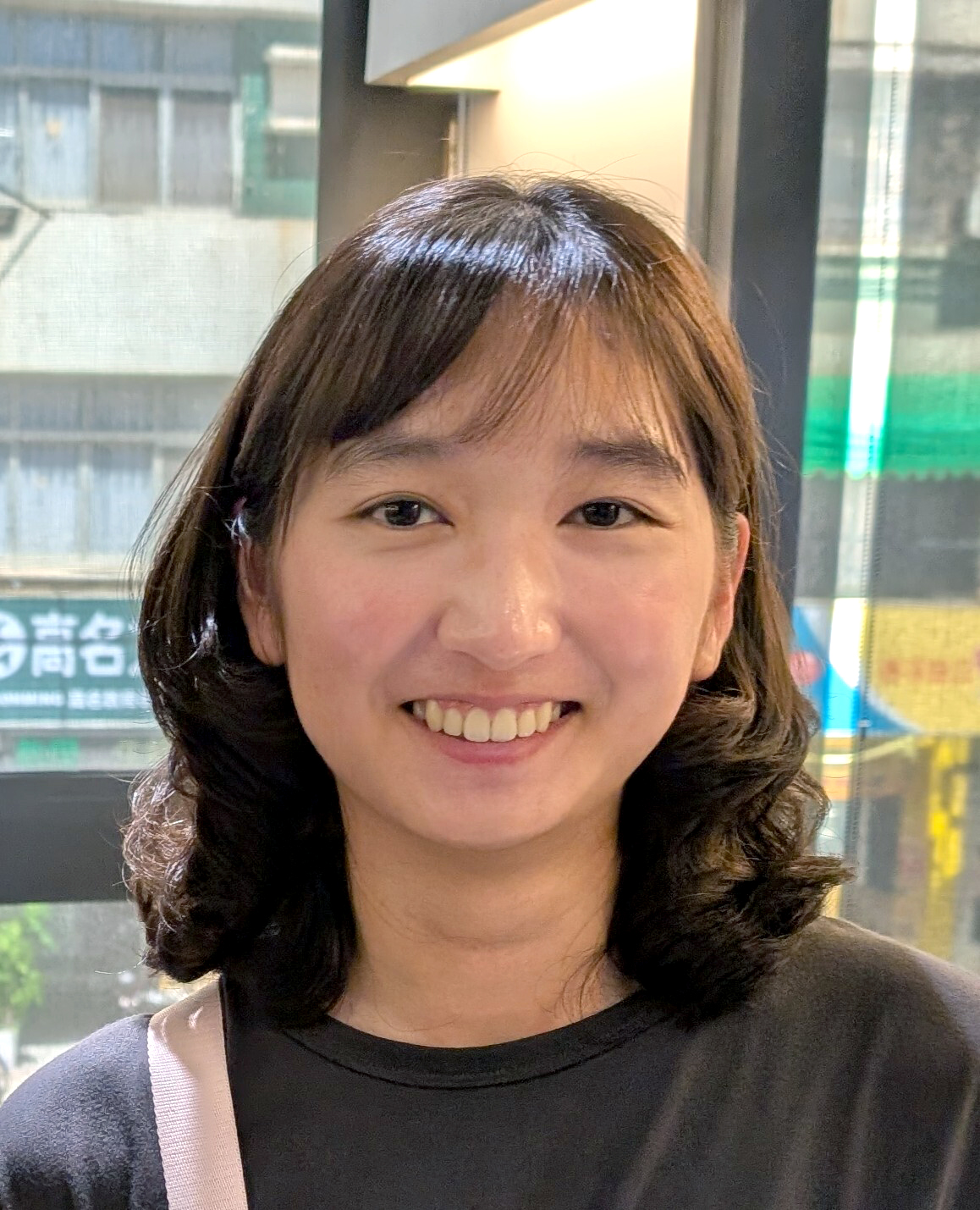 Smiling young woman with shoulder-length hair.