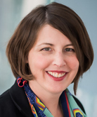 Smiling woman with short brown hair.