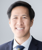Smiling man in a suit.
