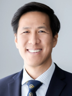 Smiling man in a suit.