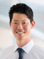 Smiling man in a dress shirt.