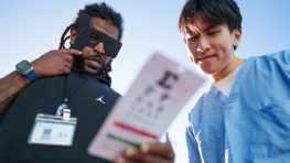 A medical worker giving a patient an eye exam.