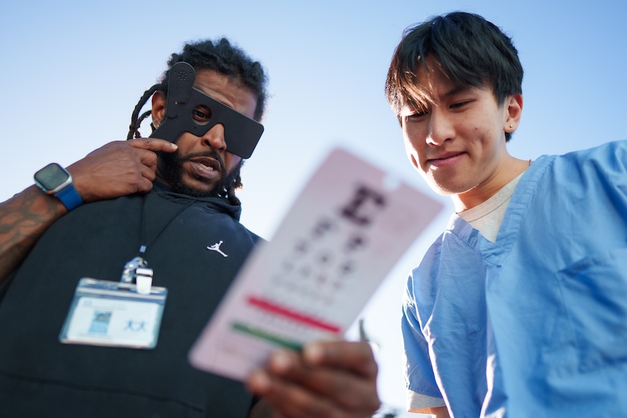 A medical worker giving a patient an eye exam.