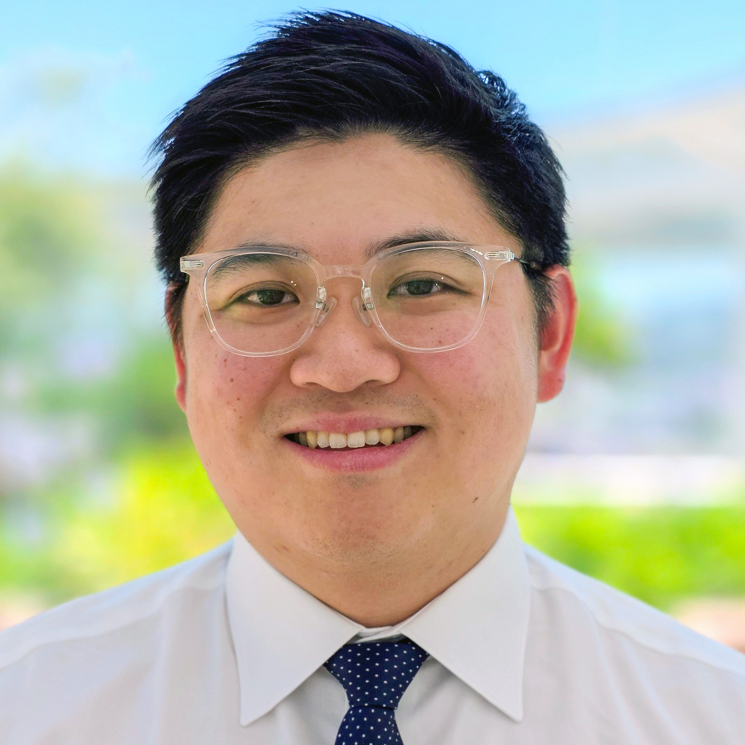 Smiling man with glasses.