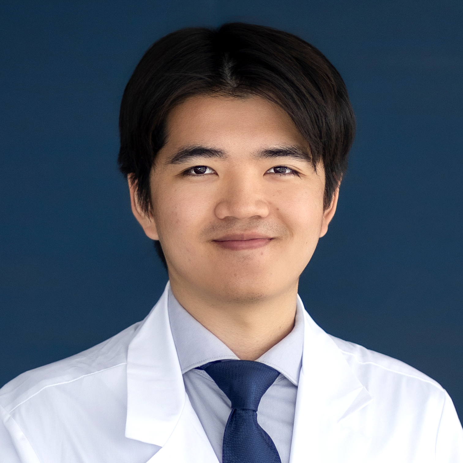 Young man in white coat
