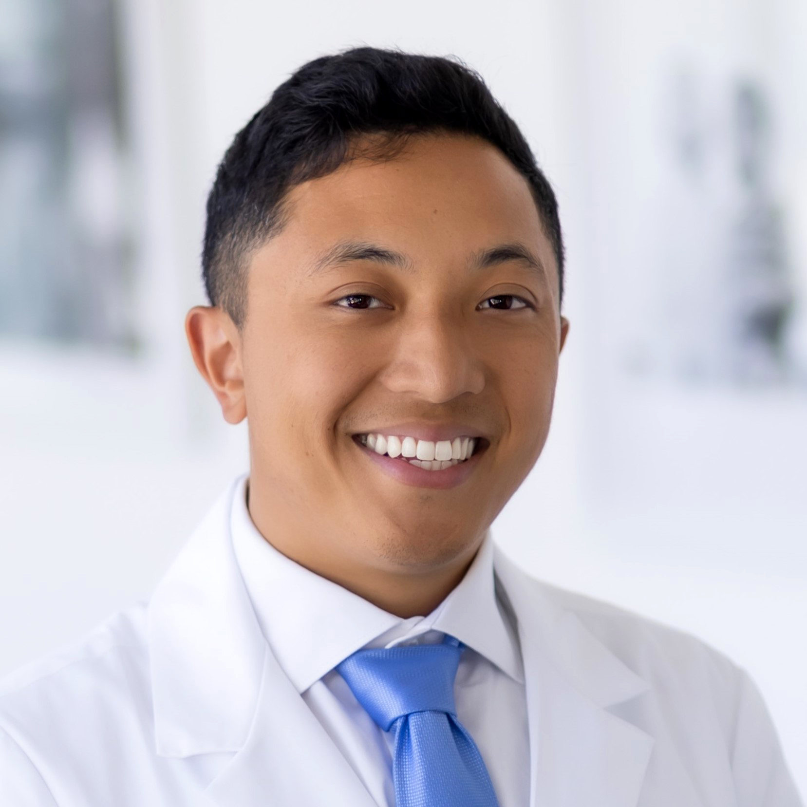 Smiling man in white coat