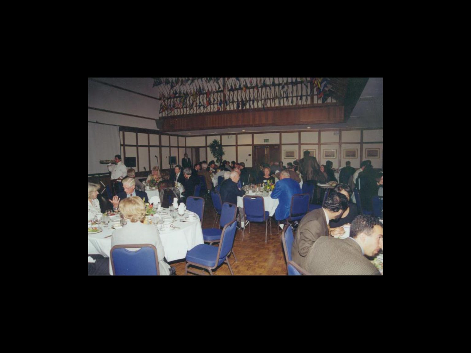 Archival photograph 28 from the 1999, 40th reunion of the Frederick C. Cordes Eye Society., showing Frederick C. Cordes Eye Society members at a reunion or banquet event.