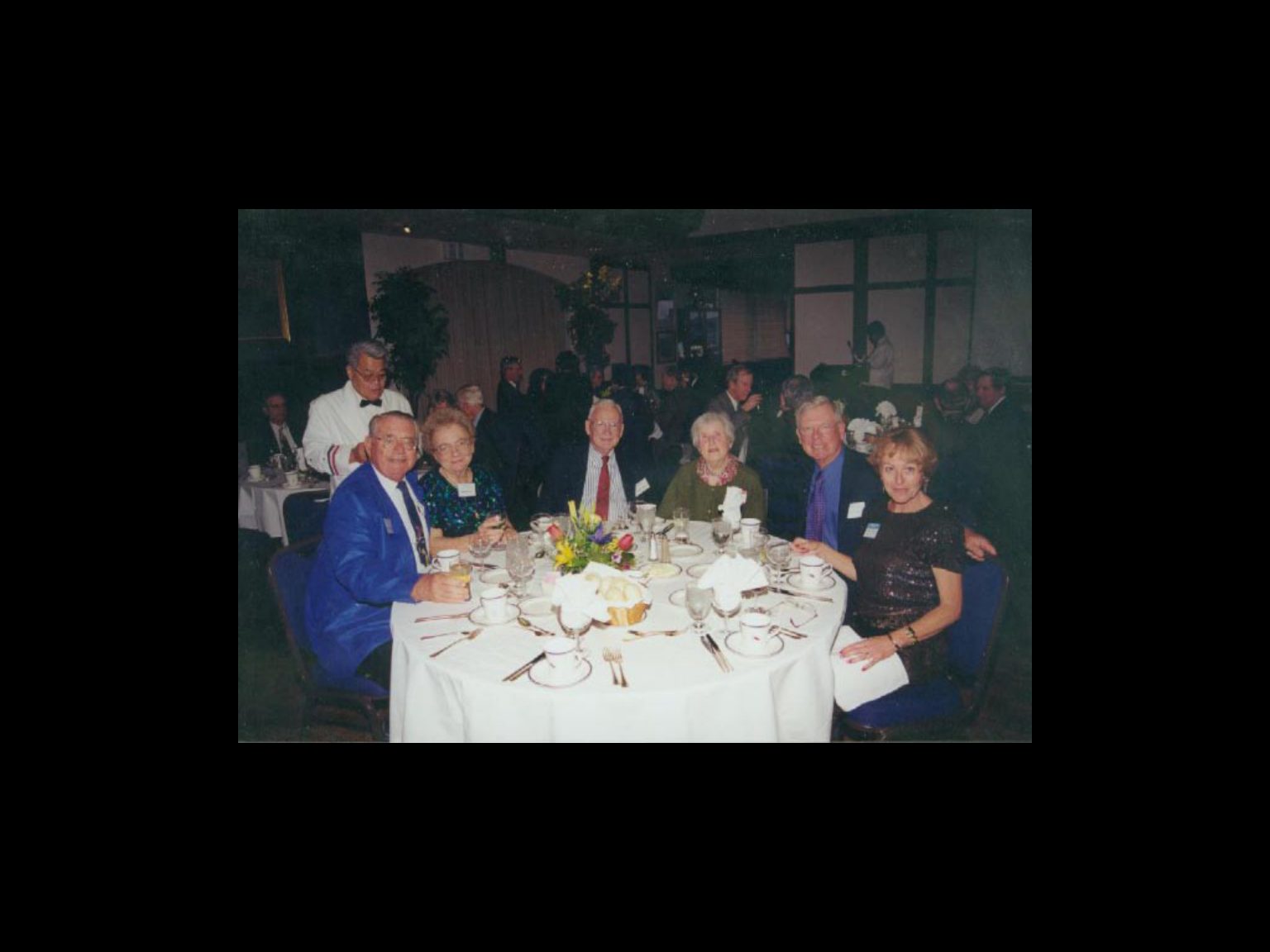 Archival photograph 36 from the 1999, 40th reunion of the Frederick C. Cordes Eye Society., showing Frederick C. Cordes Eye Society members at a reunion or banquet event.