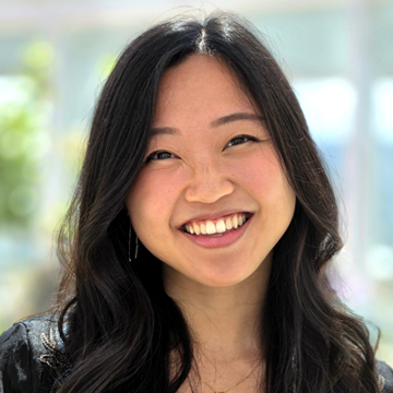 Portrait of a smiling woman with long dark hair.